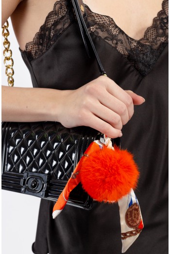 Orange pom pom bag accessory